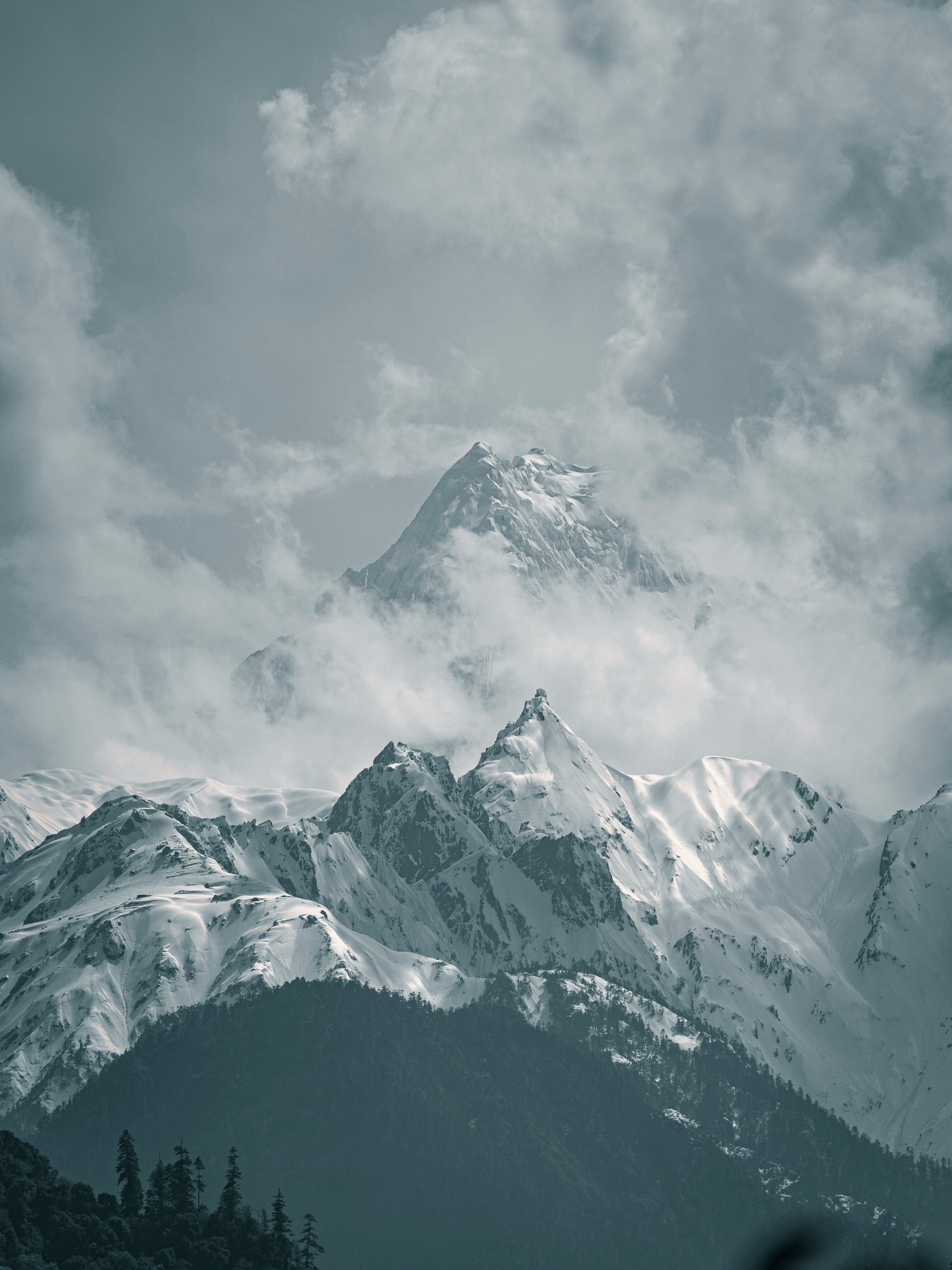 snow covered mountain under cloudy sky during daytime